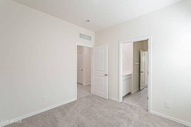 19354 W Coolidge St, Litchfield Park, AZ 85340 - unfurnished bedroom with light carpet, baseboards, and visible vents