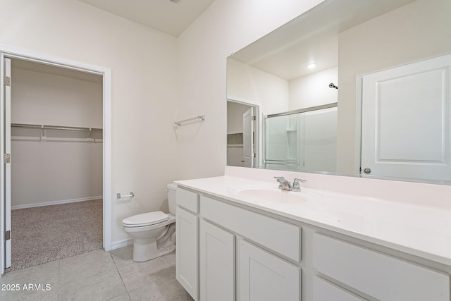 19354 W Coolidge St, Litchfield Park, AZ 85340 - bathroom with toilet, a shower stall, a walk in closet, and tile patterned floors