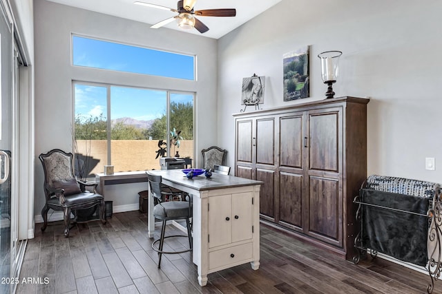 home office with ceiling fan and dark wood-type flooring