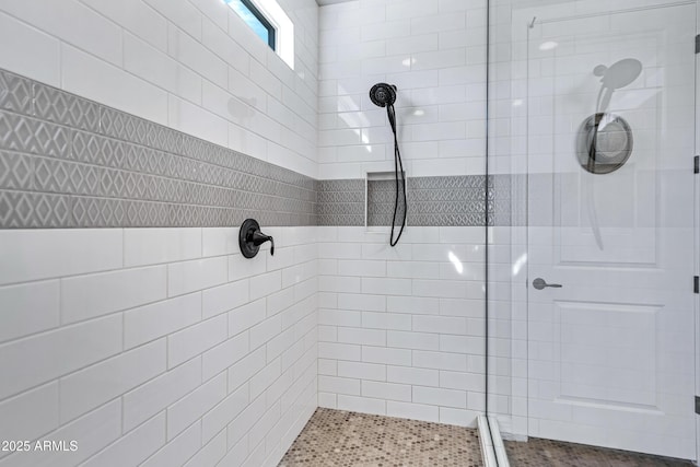 bathroom with tiled shower