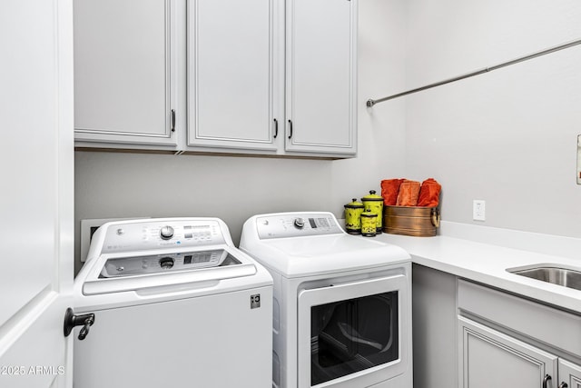 laundry room with washer and dryer and cabinets