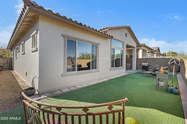 rear view of house featuring a lawn