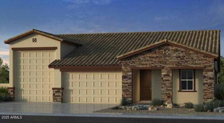 view of front facade with stone siding, stucco siding, an attached garage, and driveway