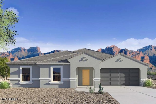 view of front facade featuring a mountain view and a garage