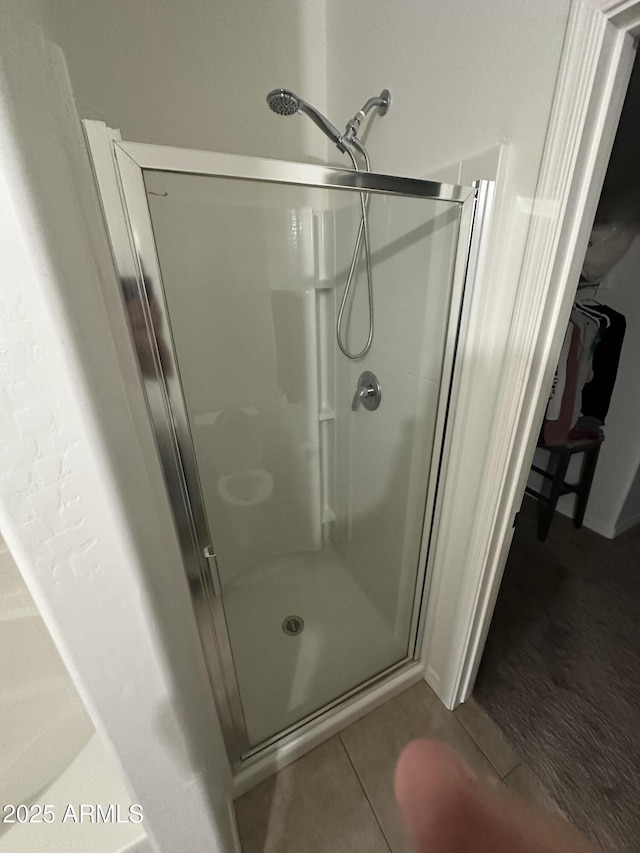 full bath featuring a shower stall and tile patterned floors