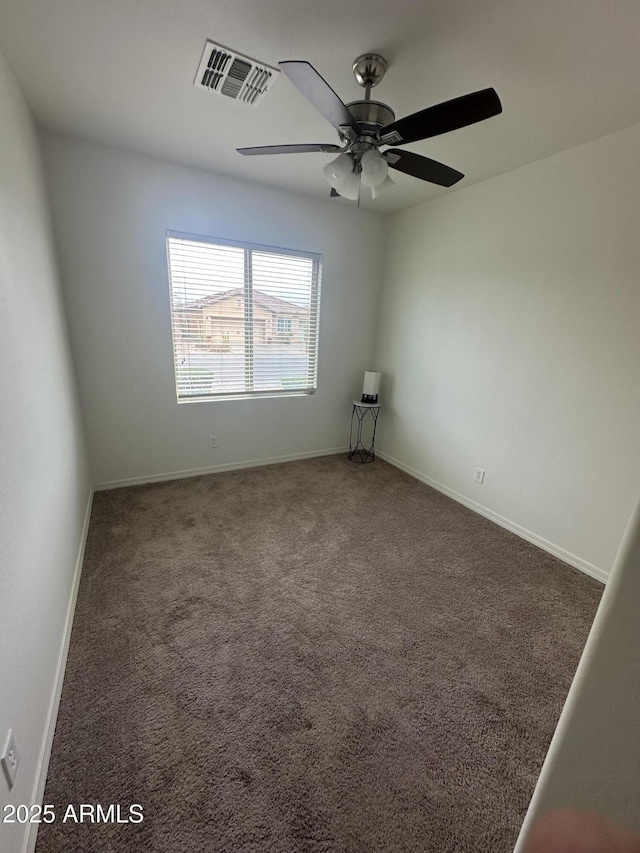 spare room featuring visible vents, a ceiling fan, baseboards, and carpet floors