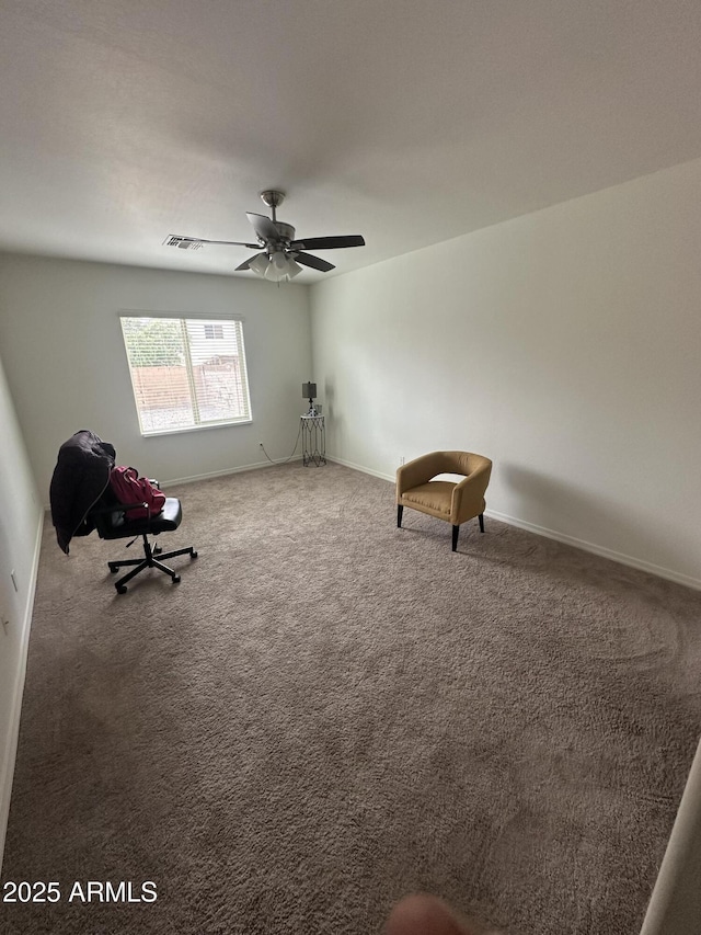 unfurnished room with visible vents, baseboards, ceiling fan, and carpet floors