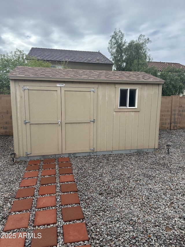 view of shed with fence