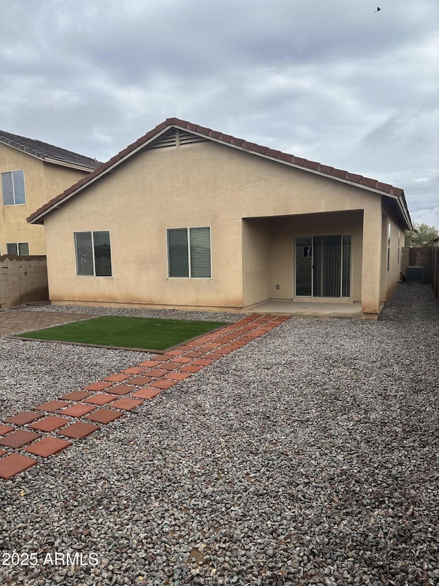 back of property with stucco siding, a patio, and a fenced backyard