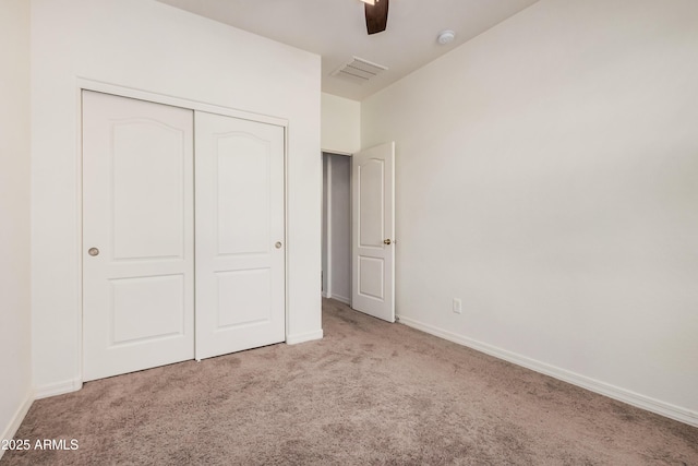 unfurnished bedroom with a ceiling fan, carpet, visible vents, baseboards, and a closet