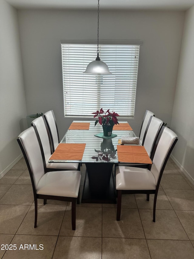 tiled dining room with baseboards