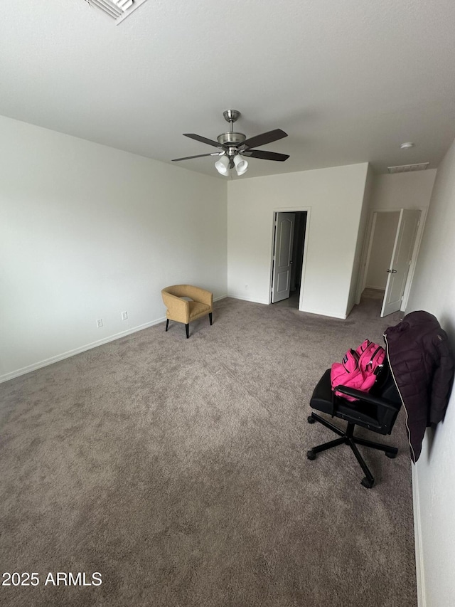 interior space featuring a ceiling fan, baseboards, and carpet floors