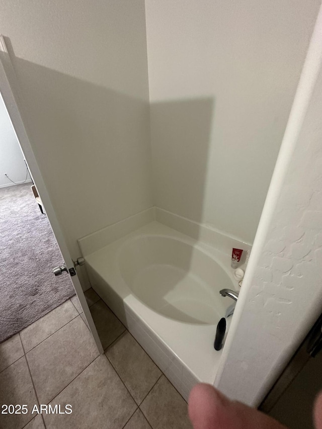 full bath featuring tile patterned floors and a bath