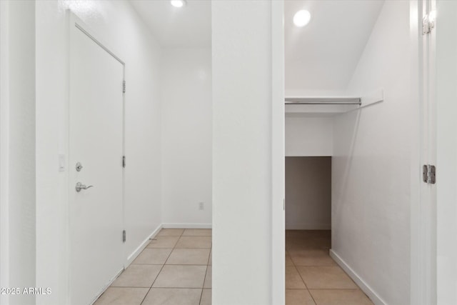 corridor featuring light tile patterned floors