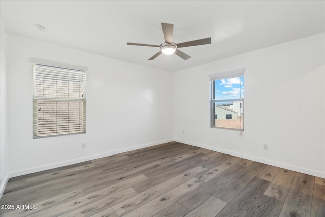 spare room featuring wood-type flooring and ceiling fan