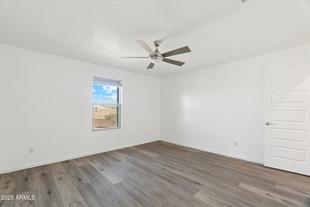 spare room with ceiling fan and light hardwood / wood-style floors