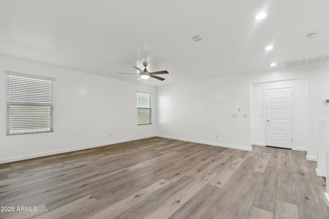 unfurnished room with ceiling fan and light wood-type flooring