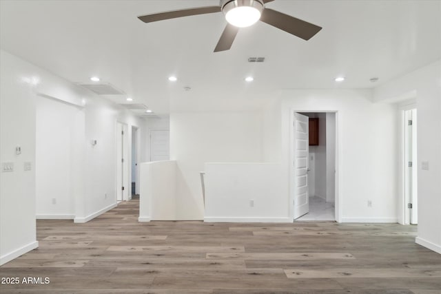 spare room featuring ceiling fan and light wood-type flooring