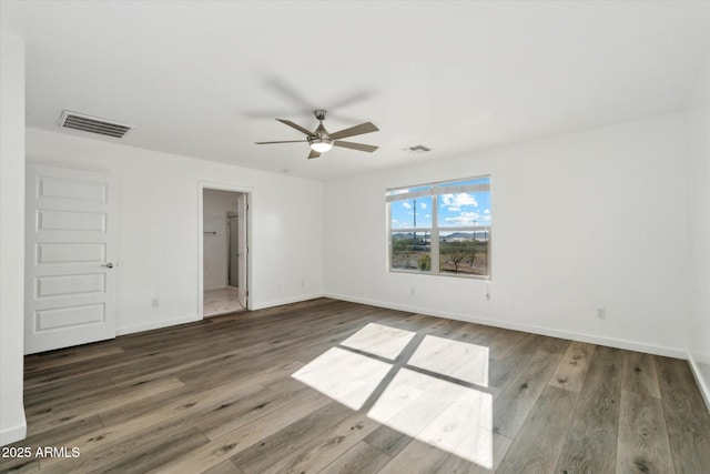 spare room featuring hardwood / wood-style flooring and ceiling fan