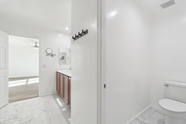 bathroom featuring ceiling fan, vanity, and toilet