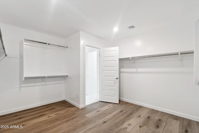 walk in closet with light wood-type flooring