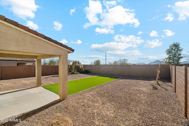 view of yard with a mountain view and a patio area