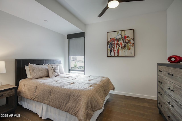 bedroom featuring a ceiling fan, dark wood-style floors, and baseboards