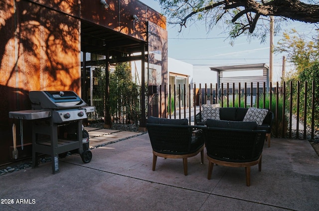 view of patio with outdoor lounge area, fence, and grilling area