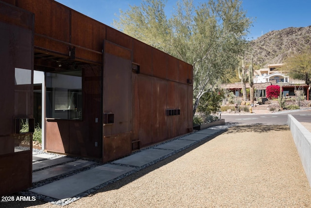 view of property exterior featuring a mountain view