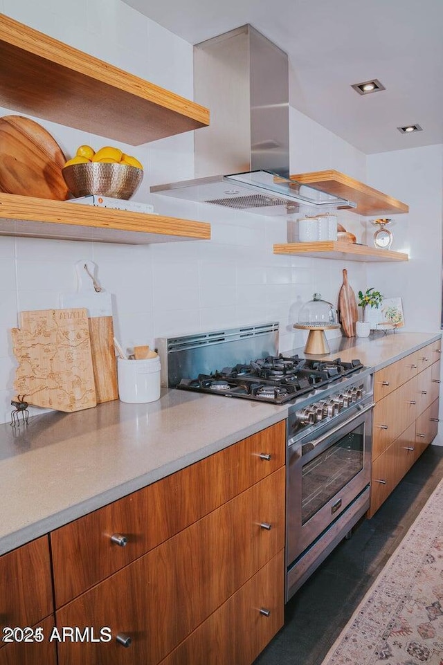 kitchen with light countertops, high end stainless steel range oven, and range hood