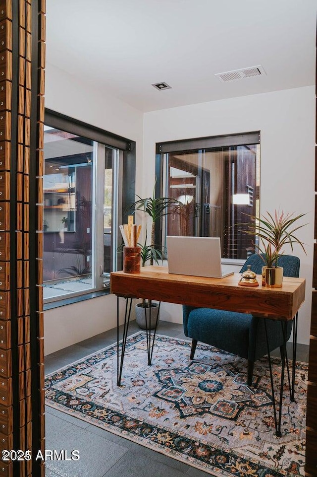 office space featuring visible vents and speckled floor