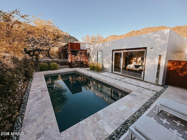 view of swimming pool with fence, a mountain view, a fenced in pool, and a patio