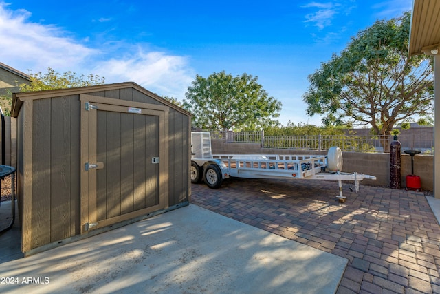 view of patio featuring a storage unit