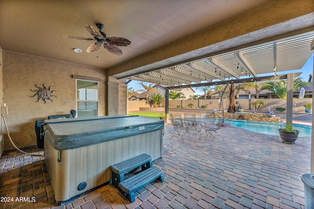 view of patio / terrace featuring ceiling fan and a swimming pool with hot tub