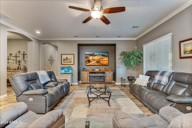 living room with crown molding, ceiling fan, and light hardwood / wood-style floors