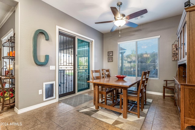 dining area with ceiling fan, light tile patterned flooring, and ornamental molding