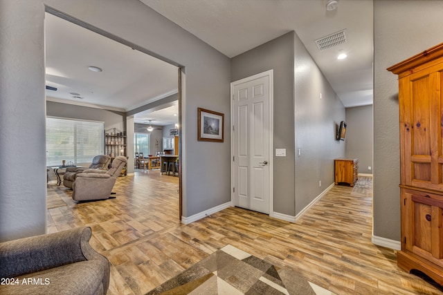 interior space featuring light hardwood / wood-style floors and ornamental molding