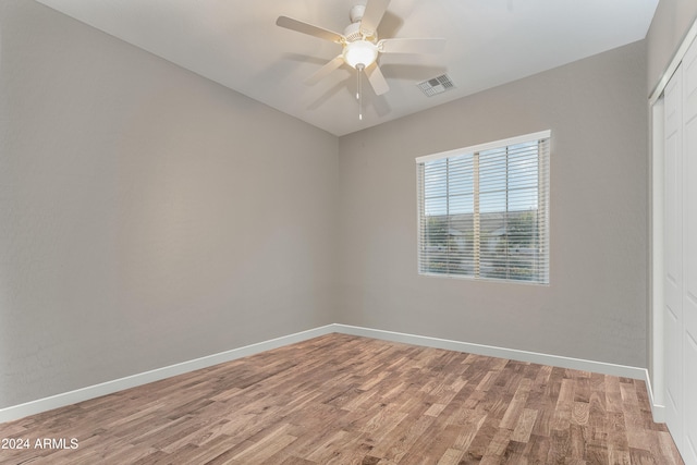 spare room featuring light wood-type flooring and ceiling fan