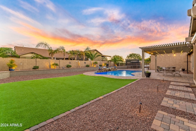 yard at dusk featuring pool water feature, a patio area, a fenced in pool, and a pergola