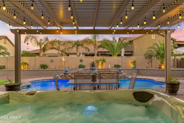 pool at dusk featuring a pergola and a hot tub