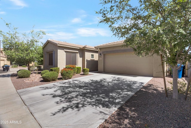 view of front of home with an attached garage, stucco siding, a tile roof, and concrete driveway