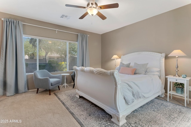 bedroom with carpet flooring, ceiling fan, and visible vents