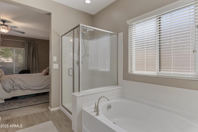bathroom with a garden tub, a stall shower, ceiling fan, and ensuite bath