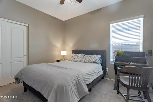 bedroom with baseboards, light carpet, a ceiling fan, and visible vents