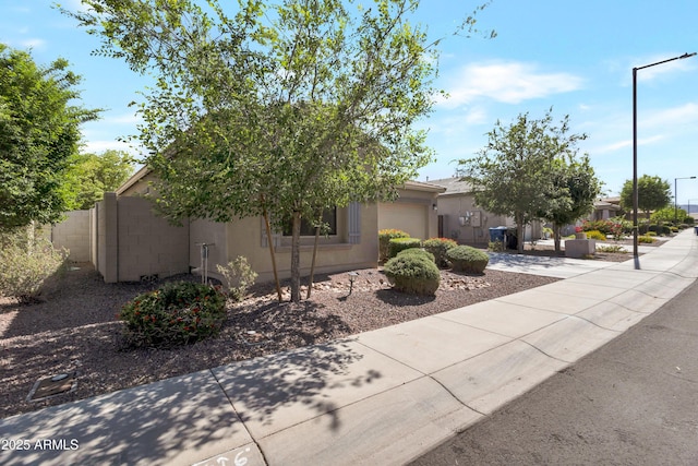 view of front of house with a garage and stucco siding