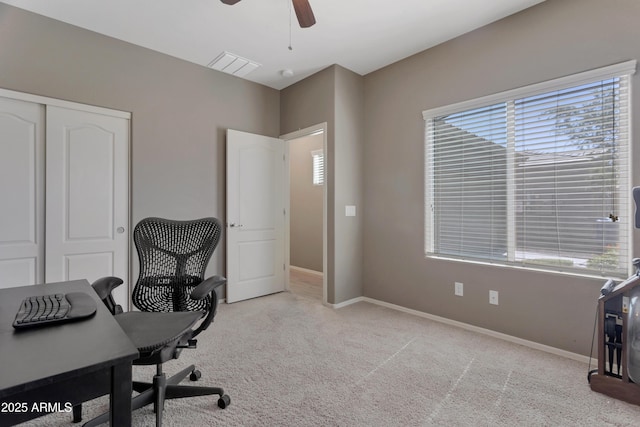 carpeted home office with ceiling fan, visible vents, and baseboards