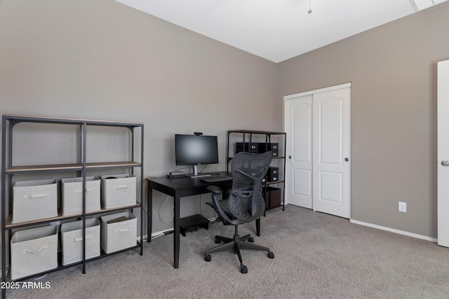 carpeted office space featuring baseboards