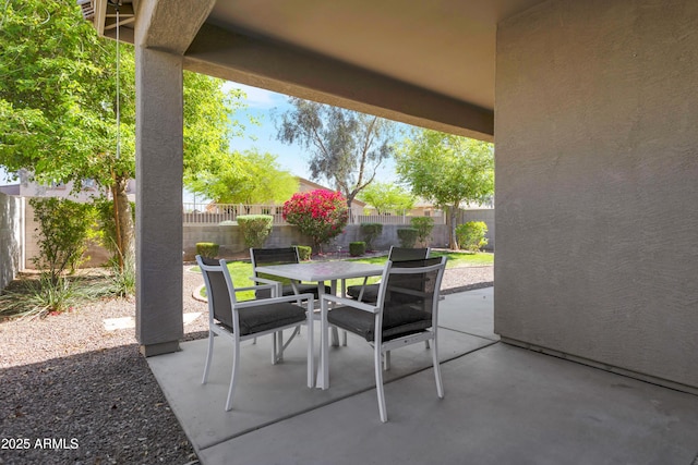 view of patio featuring outdoor dining area and a fenced backyard