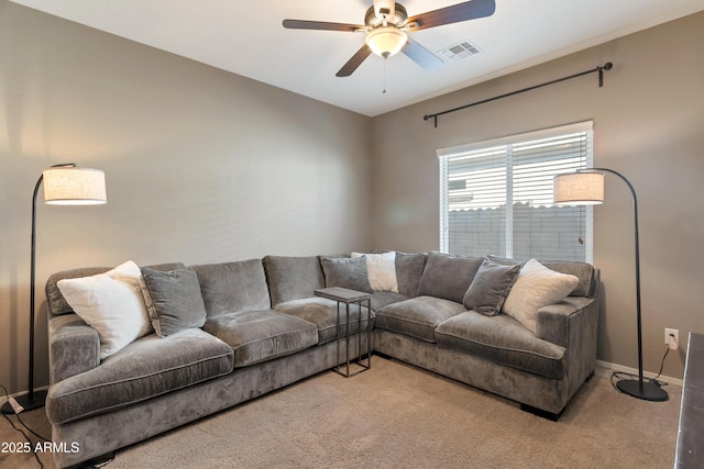 living area with carpet flooring, a ceiling fan, baseboards, and visible vents