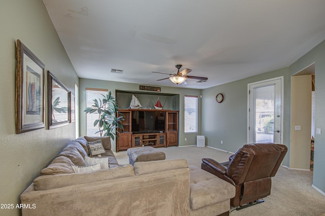 living room with light carpet, a wealth of natural light, and visible vents